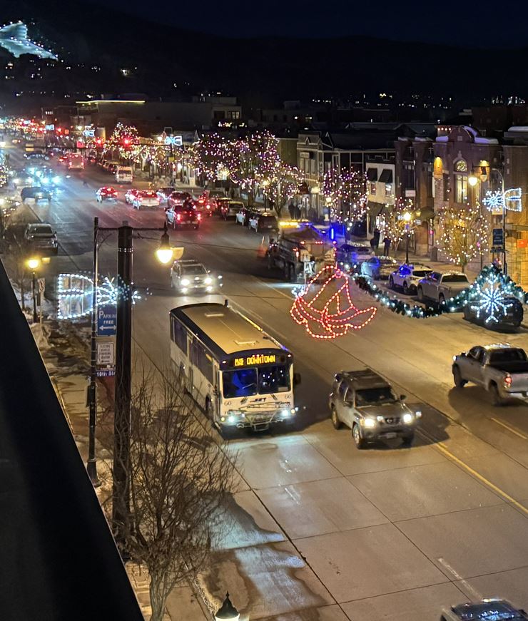 SST bus driving down main street at night